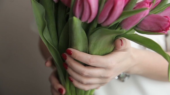 Young Romantic Woman with a Bouquet of Pink Tulips