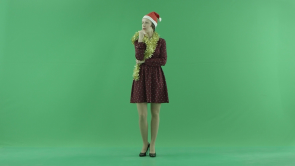 A Young Christmas Woman Is Thinking on the Green Screen