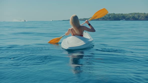 Girl In Kayak Summer Trip. Woman Exploring Calm Sea By Canoe On Holiday Vacation Weekend. alt