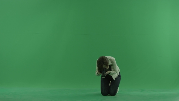 Sitting Young Woman Is Taking  Photos on the Green Screen