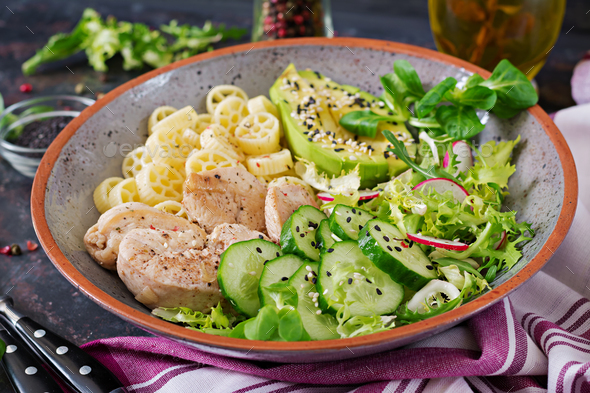 Healthy salad with chicken, avocado, cucumber, lettuce, radish and pasta - Stock Photo - Images