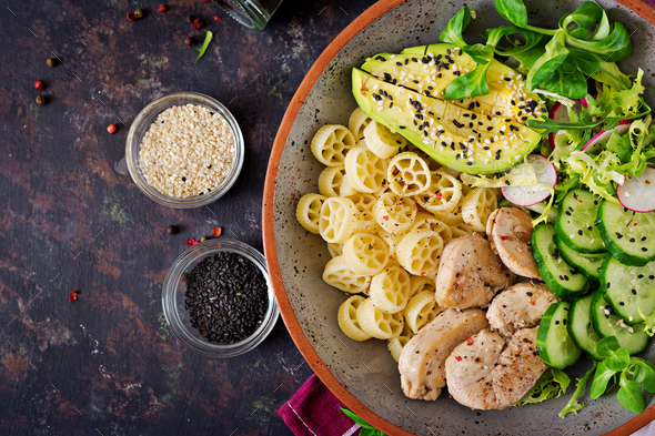 Healthy salad with chicken, avocado, cucumber, lettuce, radish and pasta - Stock Photo - Images