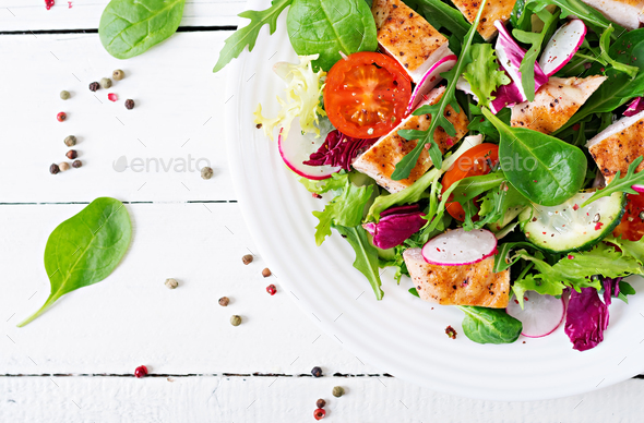 Fresh vegetable salad with grilled chicken breast - tomatoes, cucumbers, radish - Stock Photo - Images