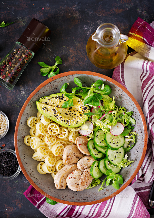Healthy salad with chicken, avocado, cucumber, lettuce, radish and pasta - Stock Photo - Images