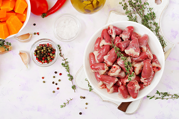 Ingredients for cooking chicken hearts with pumpkin and tomatoes in tomato sauce - Stock Photo - Images