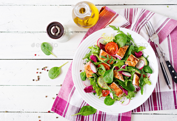 Fresh vegetable salad with grilled chicken breast - tomatoes, cucumbers, radish - Stock Photo - Images