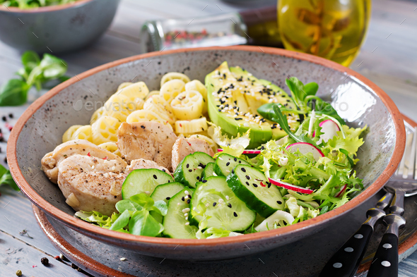 Healthy salad with chicken, avocado, cucumber, lettuce, radish and pasta - Stock Photo - Images