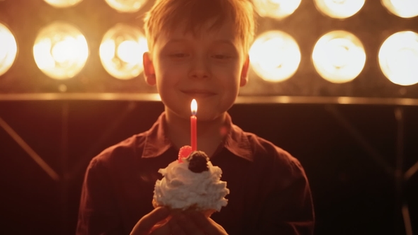 Happy Boy Blows Out a Candle and Eating Cake