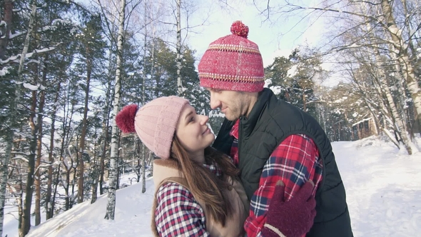Beautiful Couple of Smiling Young People in Winter Clothes in a Snowy ...