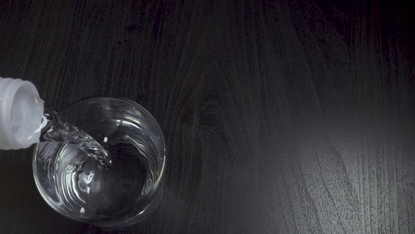 Man Pours Clean Water From a Plastic Bottle