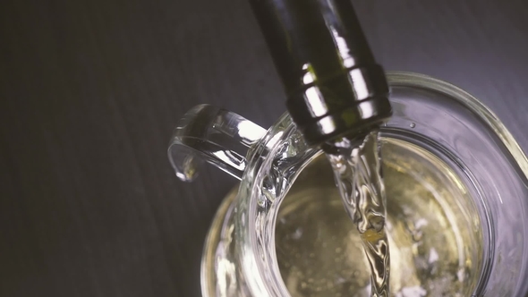 White Wine Pours Into the Decanter