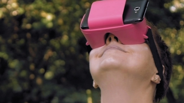 Woman Explores Virtual Reality Using VR Glasses