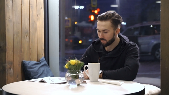 Man Is Looking on the Newspaper
