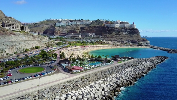 Camera Fly over the Crowded Amadores Beach at Gran Canaria