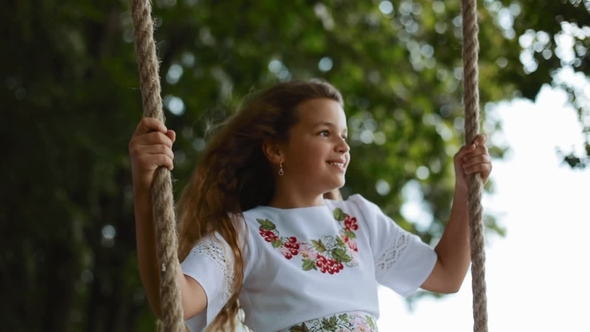 Beautiful Little Girl in a Nice White Embroidered Dress Sitting on a ...