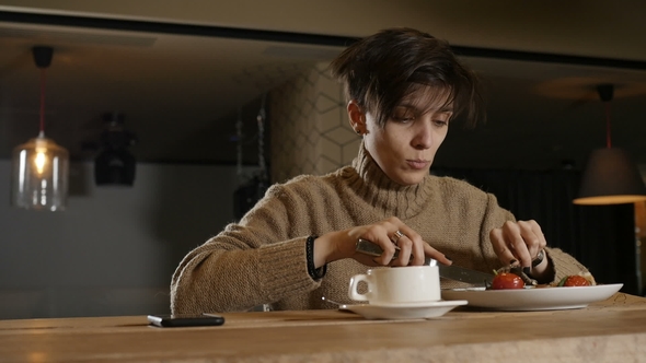 Woman Is Eating Tomatoes in Cafe