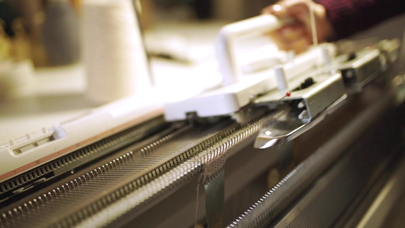 Female Hands Making Knitted Fabric on Weaving Machine in Workshop alt