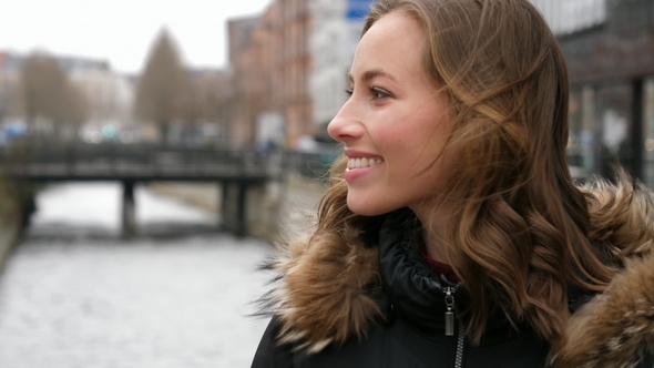 Smiling Brunette By Canal alt