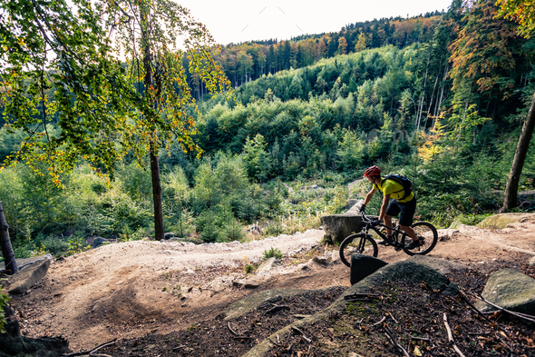 Mountain biker riding cycling in autumn forest - Stock Photo - Images