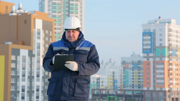 Foreman With Tablet at Major Construction Project