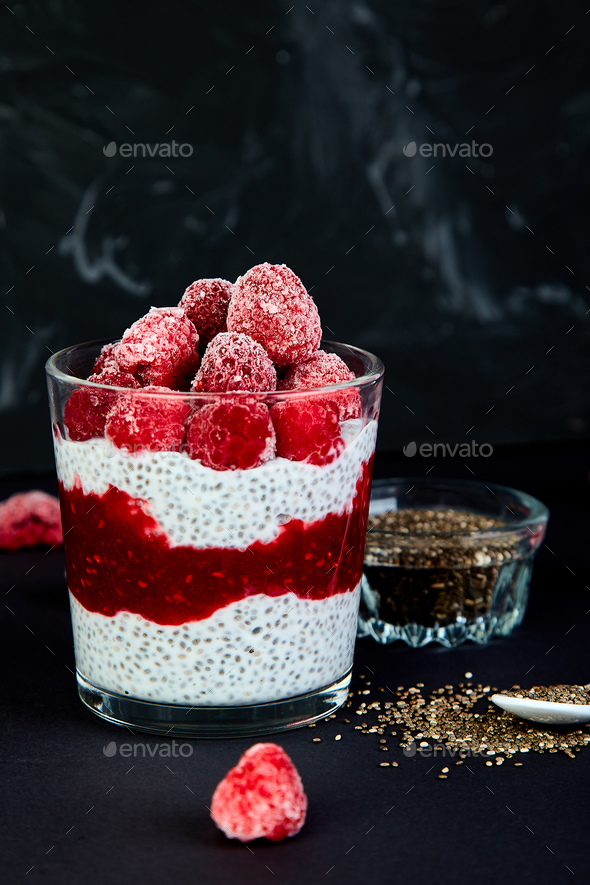 Healthy chia pudding with raspberries in glass - Stock Photo - Images