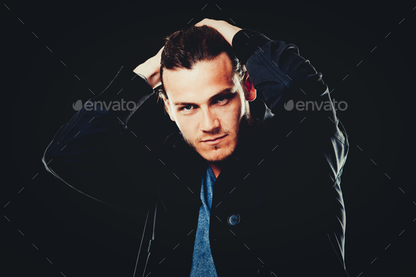 caucasian man wearing blue tshirt, black jacket and trendy hair - Stock Photo - Images