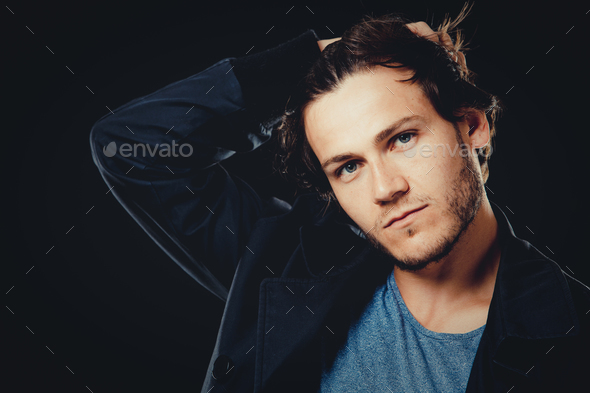 caucasian man wearing blue tshirt, black jacket and trendy hair - Stock Photo - Images