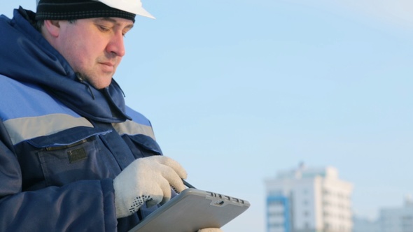 Foreman With Tablet Computer at Major Construction Project