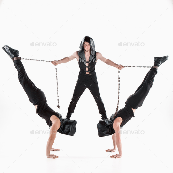 The group of gymnastic acrobatic caucasian men on balance pose - Stock Photo - Images