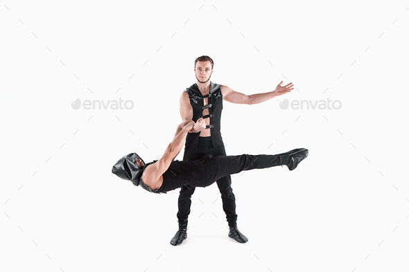The group of gymnastic acrobatic caucasian men on balance pose - Stock Photo - Images
