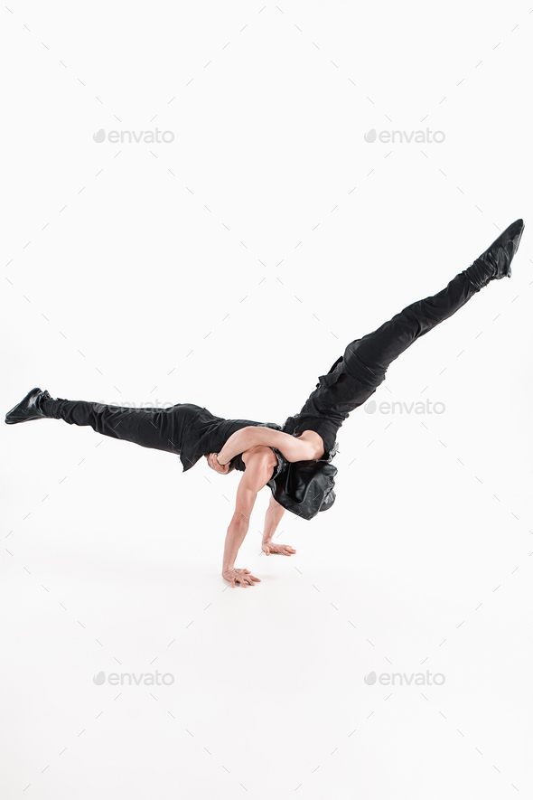 The group of gymnastic acrobatic caucasian men on balance pose - Stock Photo - Images