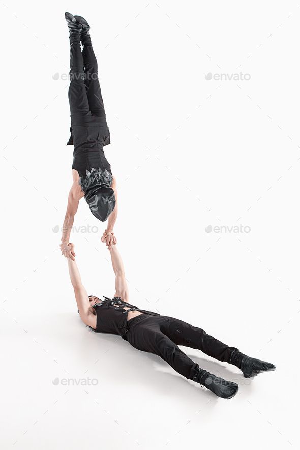 The group of gymnastic acrobatic caucasian men on balance pose - Stock Photo - Images