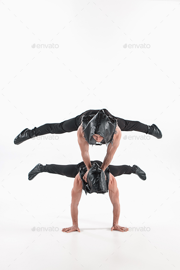 The group of gymnastic acrobatic caucasian men on balance pose - Stock Photo - Images