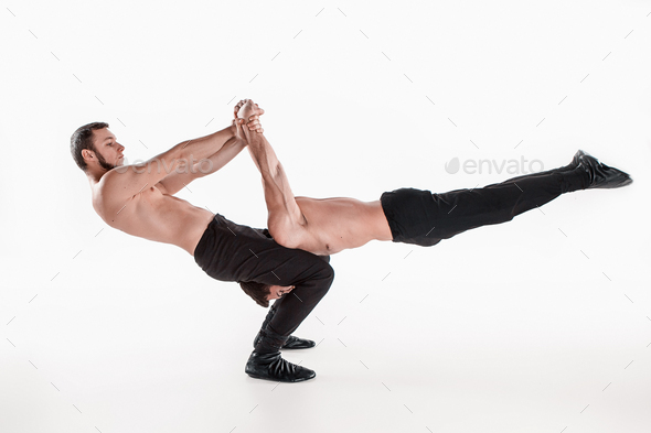 The group of gymnastic acrobatic caucasian men on balance pose - Stock Photo - Images