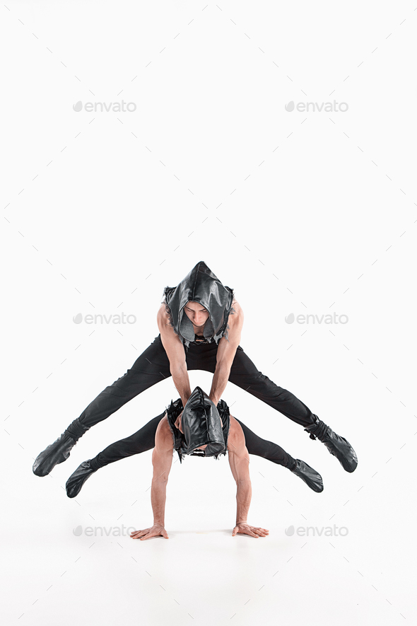 The group of gymnastic acrobatic caucasian men on balance pose - Stock Photo - Images