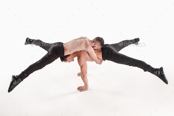 The group of gymnastic acrobatic caucasian men on balance pose - Stock Photo - Images