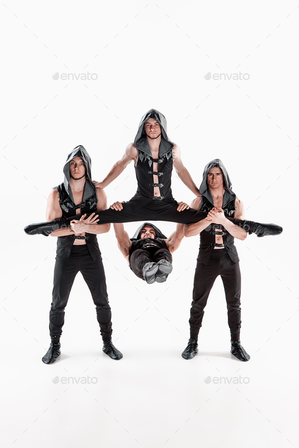 The group of gymnastic acrobatic caucasian men on balance pose - Stock Photo - Images