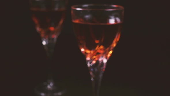 Two Glasses of Wine on a Black Background