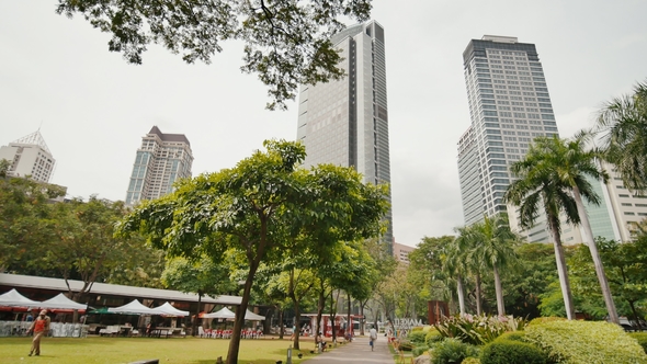 Gardens and Skyscrapers Seen at Ayala Triangle Park, in Makati, Metro Manila. alt