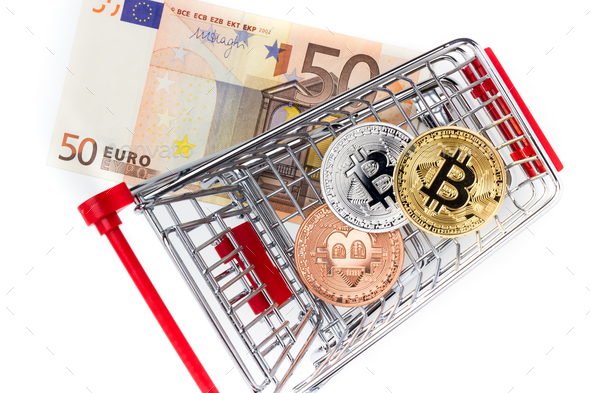 Image of bitcoins in shopping cart on euro bill - Stock Photo - Images