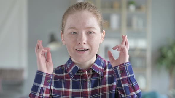 Close Up of Young Woman Optimistic With Fingers Crossed alt