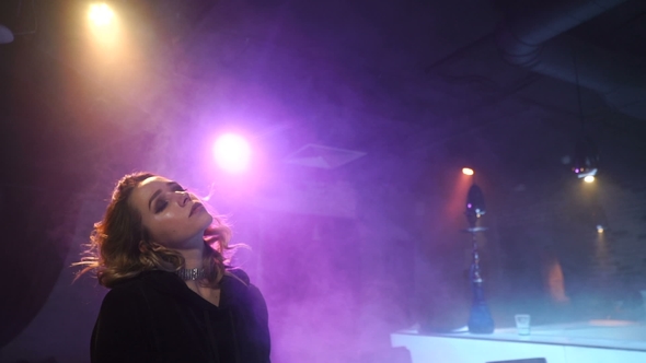 Sensual Girl Is Amid the Clouds of Smoke