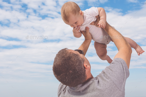 Father and son playing on the beach at the day time. - Stock Photo - Images