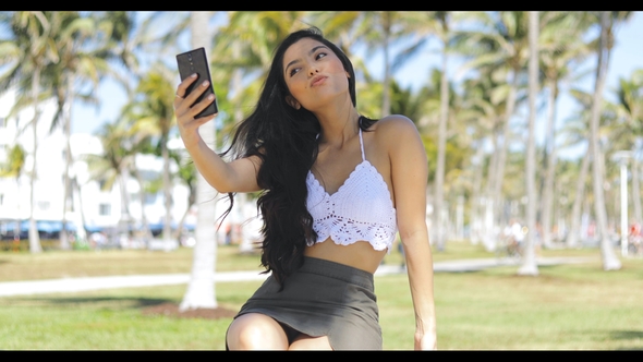 Alluring Girl Posing for Selfie in Park alt