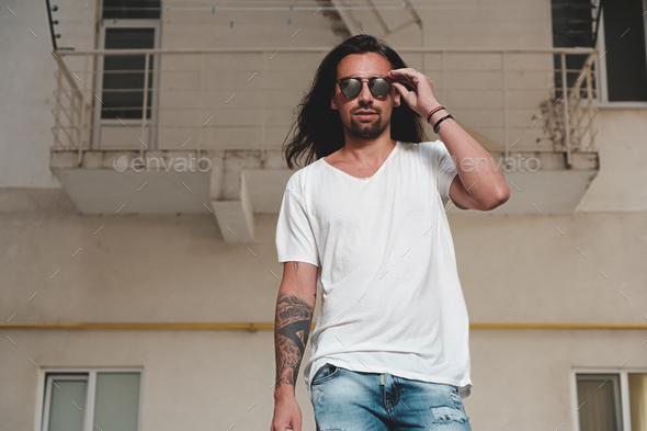Stylish bearded man model posing with sunglasses - Stock Photo - Images
