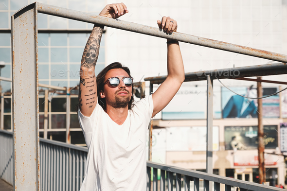 Attractive man with sunglasses hanging out in the city - Stock Photo - Images