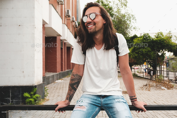 Portrait attractive man with sunglasses on urban background smil - Stock Photo - Images