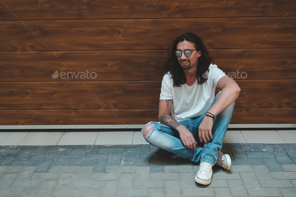 Stylish young man posing with fashionable sunglasses - Stock Photo - Images