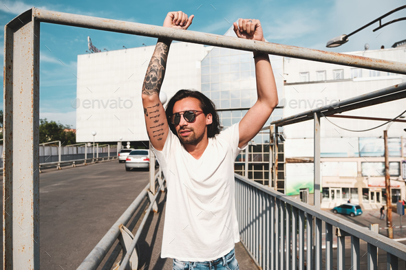 Attractive man with sunglasses hanging out in the city - Stock Photo - Images