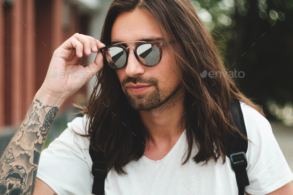 Portrait attractive man with sunglasses on urban background smil - Stock Photo - Images